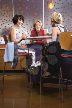 Royalty Free Photo of Older Women Sitting at a Table in a Health Club Cafeteria