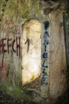 Royalty Free Photo of the Doorway of abandoned building structure with spray painted graffiti