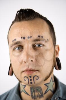 Royalty Free Photo of a Man With Tattoos and Piercings