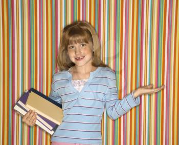 Royalty Free Photo of a Little Girl Holding Textbooks