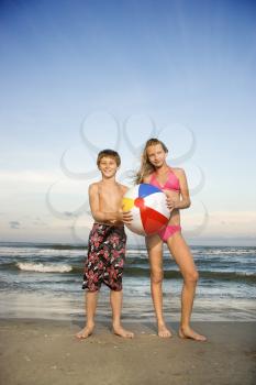 Royalty Free Photo of a Boy and Girl Holding a Ball on a Beach