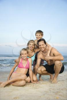 Royalty Free Photo of a Family of Four Posing Together on a Beach