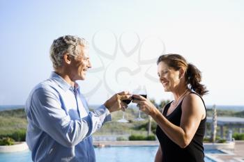 Royalty Free Photo of a Caucasian Couple Making Toast With Wine Glasses