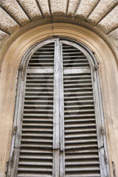 Royalty Free Photo of a Close-up of Wooden Shutters and an Arched Window in Rome, Italy