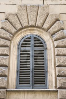 Royalty Free Photo of Arched Window With Closed Shutters in Rome, Italy