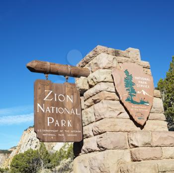 Royalty Free Photo of a Wooden and Stone Sign for Zion National Park, Utah