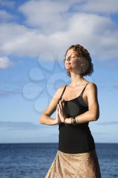 Royalty Free Photo of a Woman Meditating by the Pacific Ocean of Maui, Hawaii
