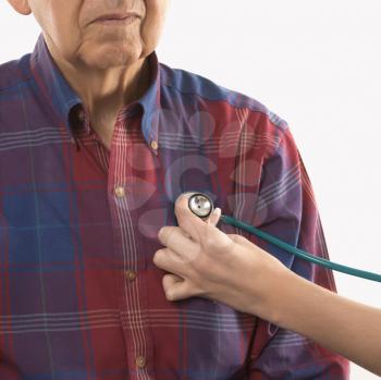 Royalty Free Photo of a Female Hand With a Stethoscope at an Elderly Male's Chest
