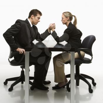 Royalty Free Photo of a Businessman and Businesswoman Arm Wrestling