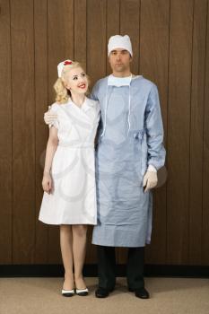 Royalty Free Photo of a Female Nurse and Male Doctor Standing Together and Smiling