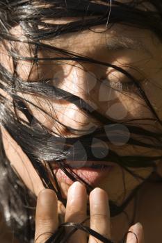 Royalty Free Photo of a Female With Wet Hair Covering Her Face