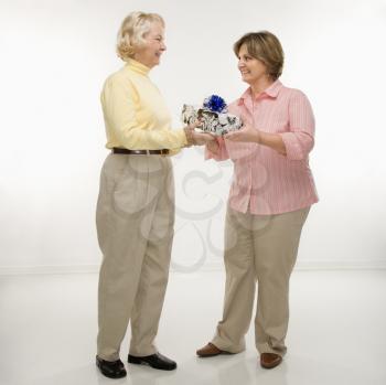 Royalty Free Photo of a Woman Giving Her Friend a Present