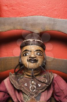 Royalty Free Photo of a Close-up of a Wooden Puppet Sitting on a Chair