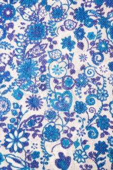 Royalty Free Photo of a Close-Up of Woven Vintage Fabric With Blue Flowers and Designs Printed on Cotton