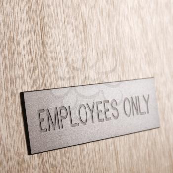 Royalty Free Photo of an Employees Only Sign on a Wooden Door