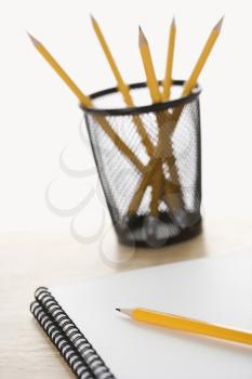 Royalty Free Photo of Pencils and Spiral Bound Notebooks Arranged on a Desk