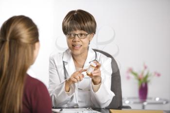 Royalty Free Photo of a Doctor Explaining Medication to a Patient