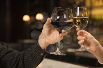 Royalty Free Photo of Male and Female Hands Toasting Wine Glasses