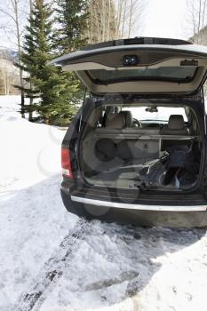 Royalty Free Photo of an SUV With Ski Equipment in a Winter Setting