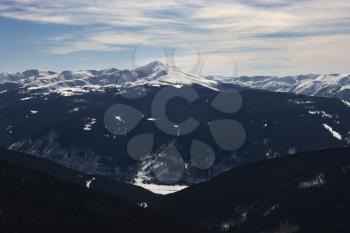 Snow covered mountain peaks with valley in Colorado.