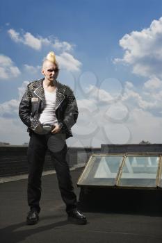 Royalty Free Photo of a Punk Standing on a Roof