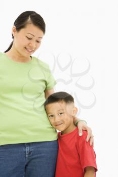 Royalty Free Photo of a Mother Standing With Her Arms Around Her Son