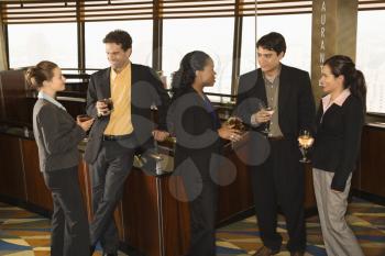 Royalty Free Photo of Businesspeople in a Bar Drinking and Conversing