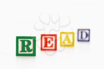 Alphabet toy building blocks spelling the word read.