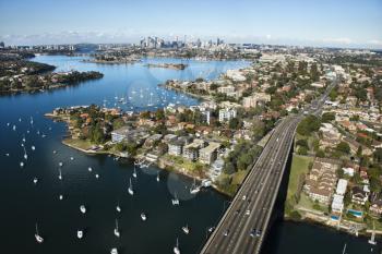 Royalty Free Photo of an Aerial View of Victoria Road Bridge and Boats With Distant Downtown Skyline in Sydney, Australia