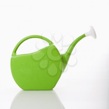 Green plastic watering can. 