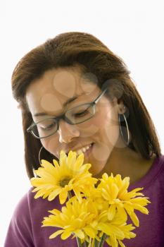 Royalty Free Photo of a Woman Smelling a Bouquet of Gerber Daisies 