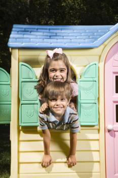 Royalty Free Photo of a Boy and a Girl Playing in a Toy House