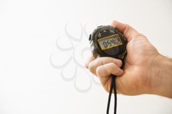 Close-up of adult male hand holding stopwatch.