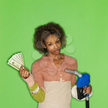 Royalty Free Photo of a Woman Holding a Gas Nozzle and Money