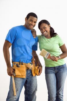 Portrait of African American male and female couple with home repair tools.
