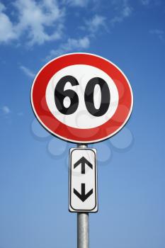 Low angle view of speed limit road sign and blue sky in Tuscany, Italy. Vertical shot.