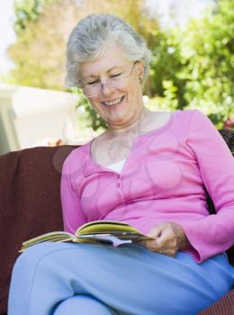 Royalty Free Photo of a Woman Reading Outside