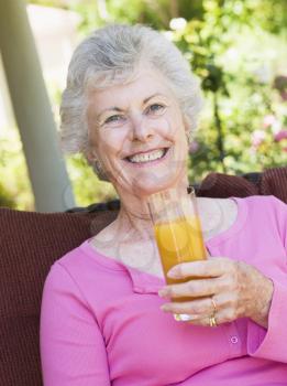 Royalty Free Photo of a Senior Woman Outside With Juice