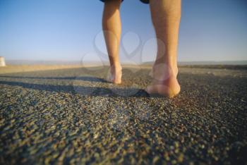 Royalty Free Photo of a Man's Feet on a Path