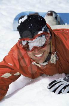 Royalty Free Photo of a Snowboarder Lying in the Snow