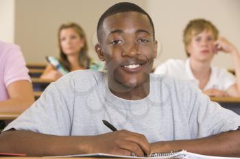 Royalty Free Photo of a Boy Taking Notes in Class