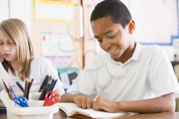 Royalty Free Photo of a Boy Reading in Class