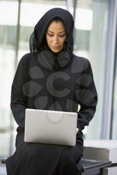 Royalty Free Photo of an Eastern Woman Sitting With a Laptop