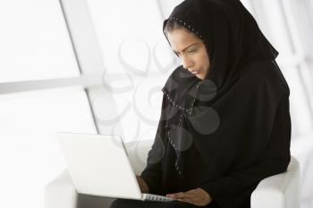 Royalty Free Photo of a Woman Indoors With a Laptop