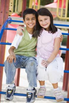 Royalty Free Photo of Two Children on Playground Equipment