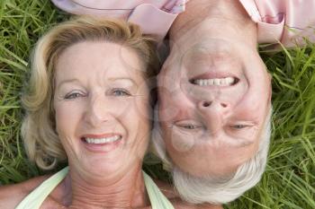 Royalty Free Photo of a Man and Woman Lying on the Grass
