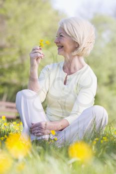 Royalty Free Photo of a Woman Holding a Buttercup