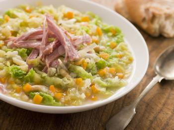 Royalty Free Photo of a Cabbage and Bacon Soup With Rustic Bread