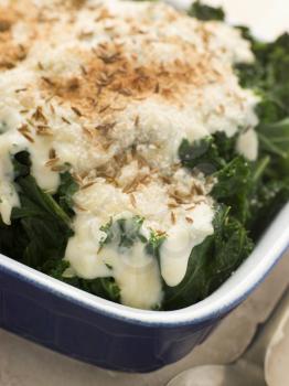 Royalty Free Photo of Curly Kale with Cheese Sauce Caraway Seeds and Breadcrumbs