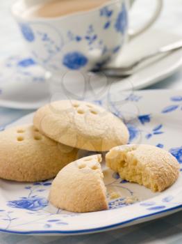 Royalty Free Photo of Wellington Button Biscuits with a Cup of Tea